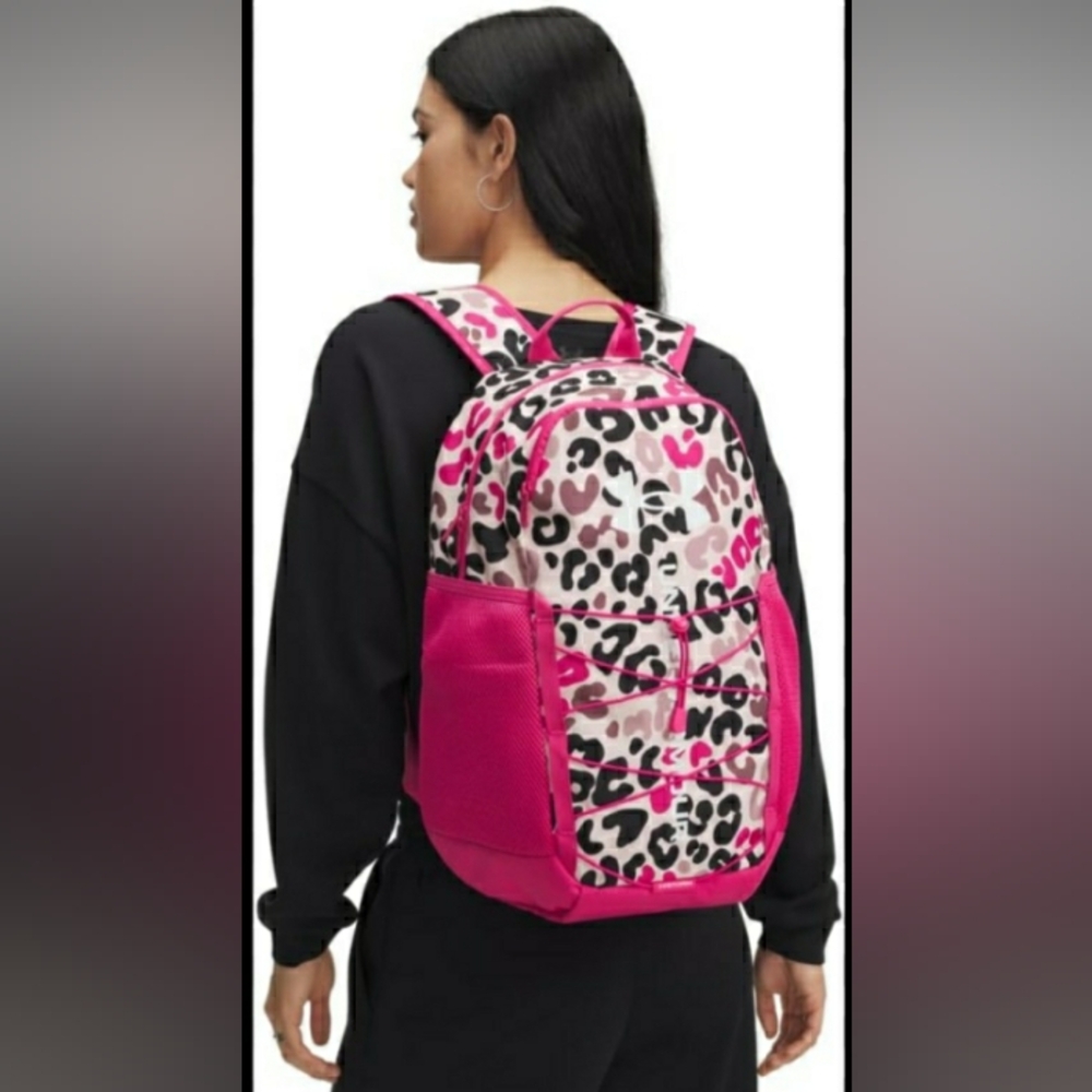 The Under Armour Hustle Sport 6.0 Backpack in Tourmaline Pink is a water-resista